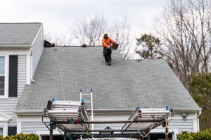 Roofer Repairing Wind Damaged Roof In Castle Rock